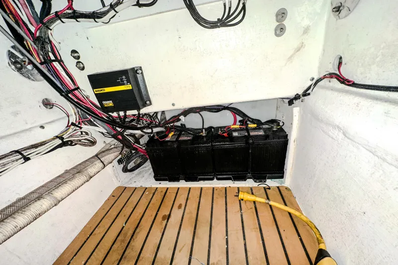 Slide: The Image of Battery compartment of 2009 Blue Fin 240 Islander boat with wiring and charger. - 26