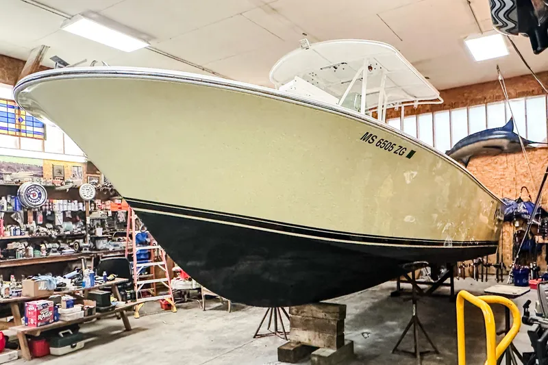 Slide: The Image of 2009 Blue Fin 240 Islander boat in a workshop, elevated on blocks. - 7