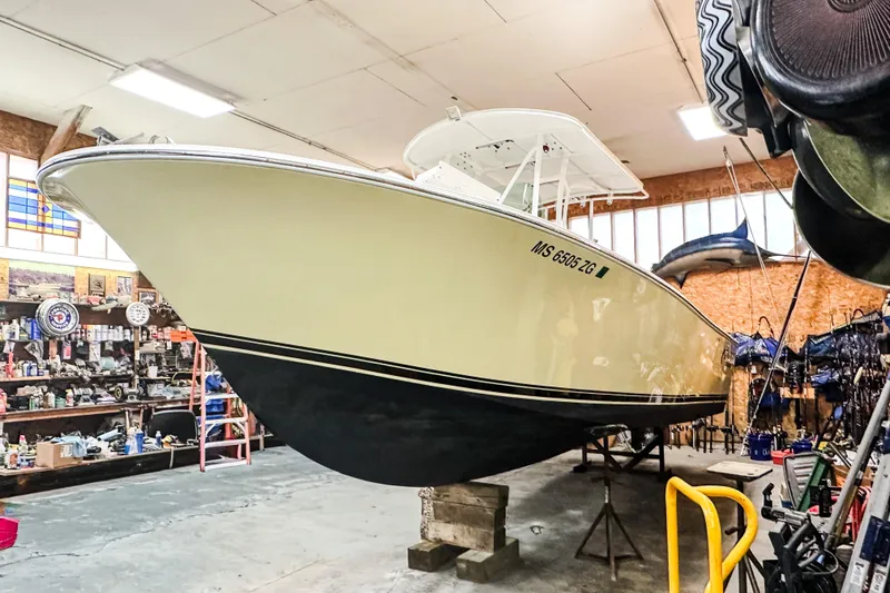 Slide: The Image of 2009 Blue Fin 240 Islander boat in a workshop, elevated on blocks. - 8