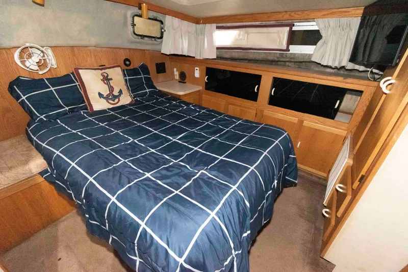 Slide: The Image of Cozy bedroom in 1990 Silverton 40 Aft Cabin yacht with nautical decor. - 19