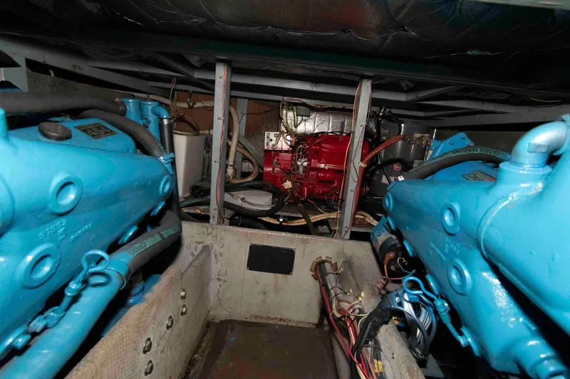 Slide: The Image of Engine room of 1990 Silverton 40 Aft Cabin with blue and red machinery. - 23