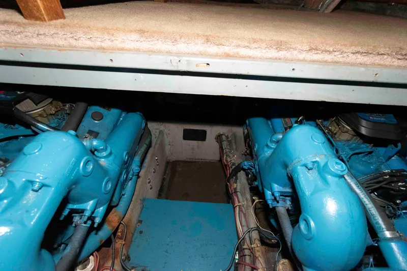 Slide: The Image of Engine room of 1990 Silverton 40 Aft Cabin with blue engines visible. - 24