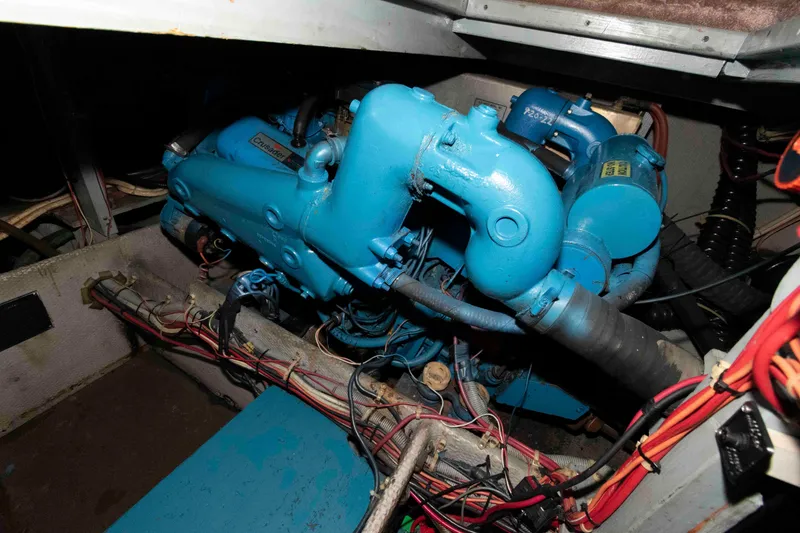 Slide: The Image of Engine room of 1990 Silverton 40 Aft Cabin with blue machinery and wiring. - 26