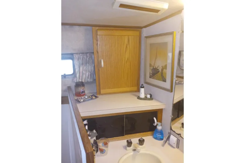 Slide: The Image of 1990 Silverton 40 Aft Cabin interior with enclosed deck and marina view. - 5