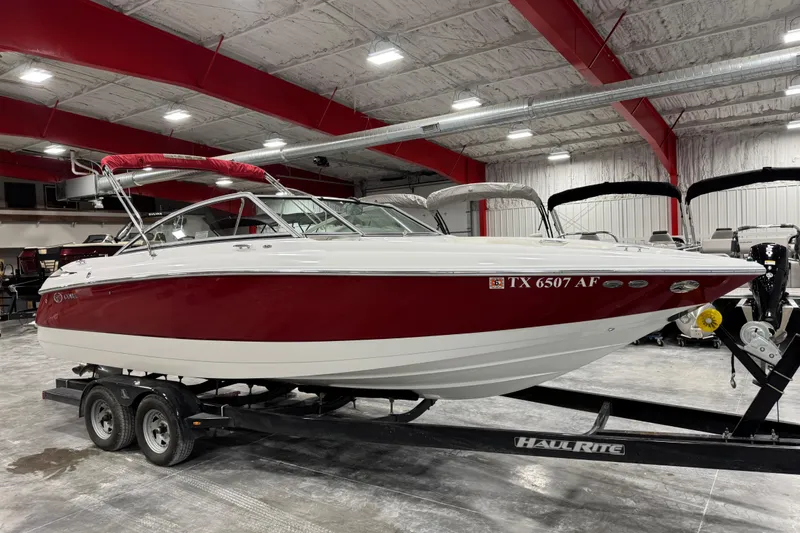 Slide: The Image of 2006 Cobalt 24SX boat with red and white exterior on a trailer in a showroom. - 10