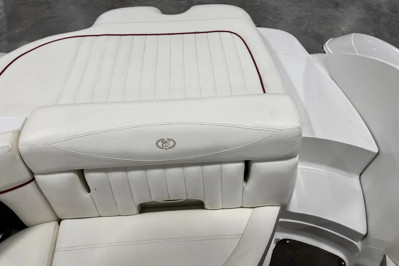 Slide: The Image of White leather seating on a 2006 Cobalt 24SX boat, featuring red accents. - 15