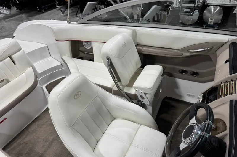 Slide: The Image of Interior of a 2006 Cobalt 24SX boat with white leather seating and steering wheel. - 17