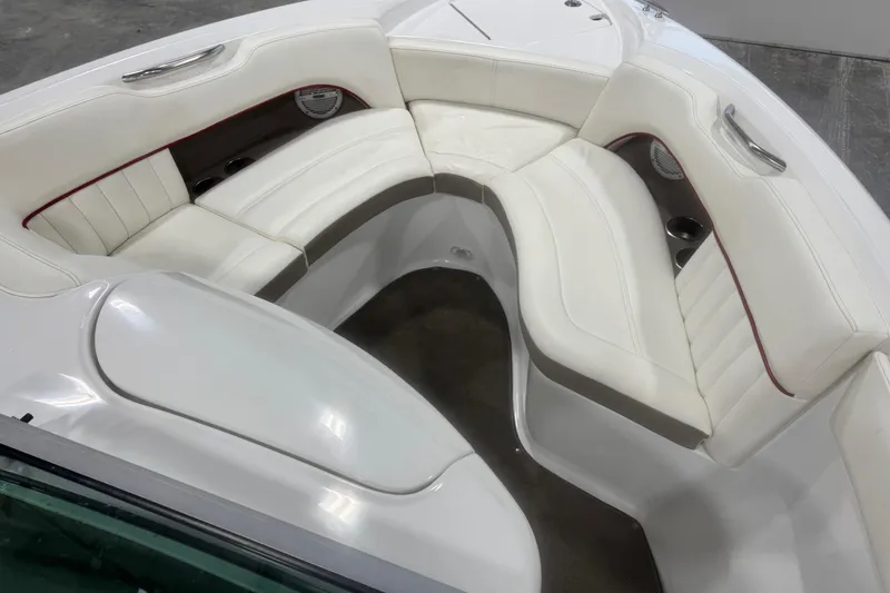 Slide: The Image of 2006 Cobalt 24SX boat interior with white leather seating and cup holders. - 18