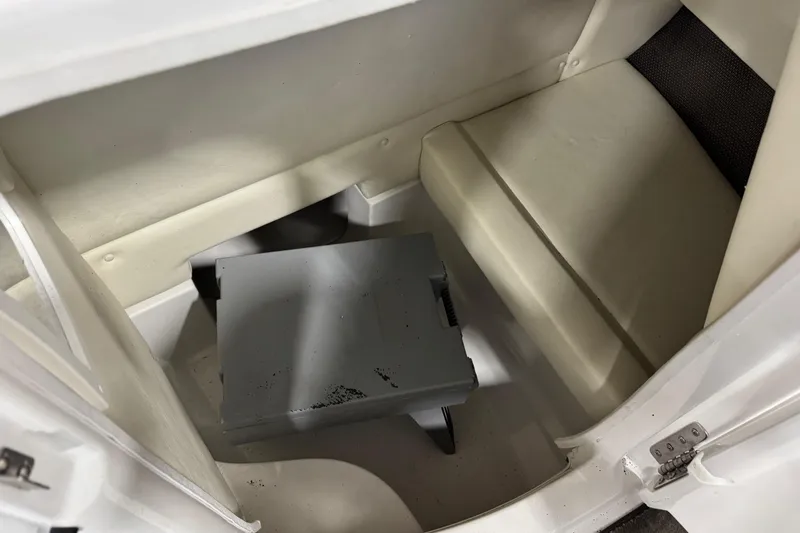 Slide: The Image of 2006 Cobalt 24SX boat interior with seating and storage compartment. - 19