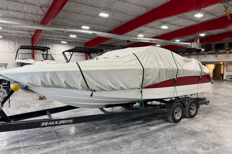 Slide: The Image of 2006 Cobalt 24SX boat covered on trailer in indoor storage facility. - 20