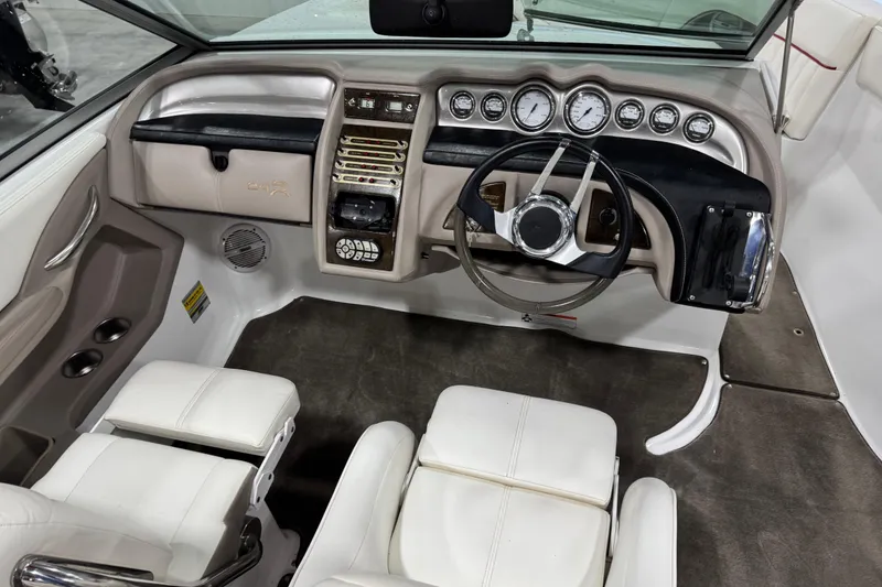 Slide: The Image of 2006 Cobalt 24SX boat dashboard with steering wheel and instrument panel. - 25