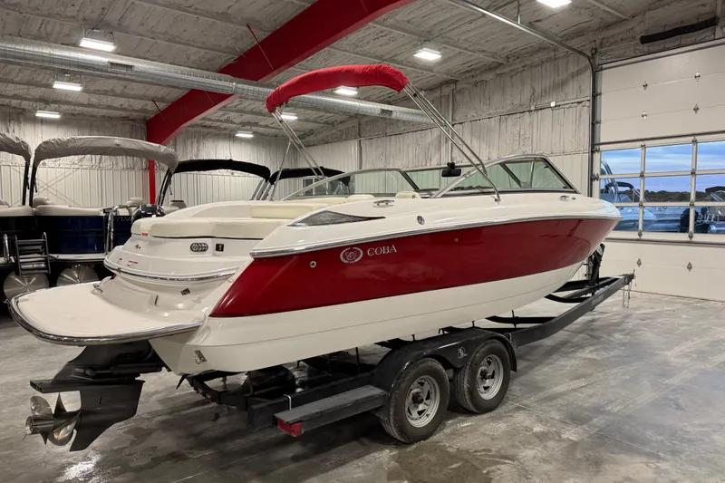 Slide: The Image of 2006 Cobalt 24SX boat with red and white design in indoor storage. - 3