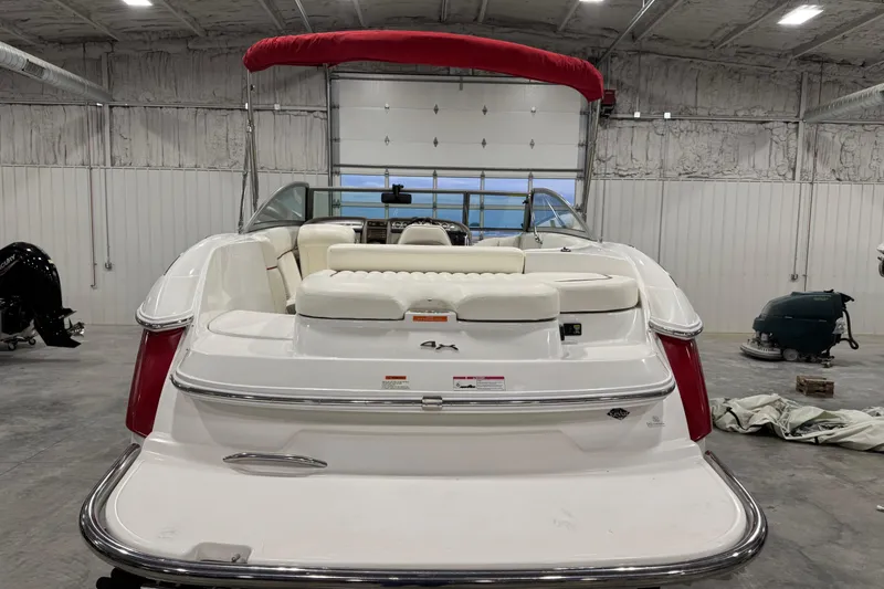 Slide: The Image of 2006 Cobalt 24SX boat with red canopy in a garage setting. - 5