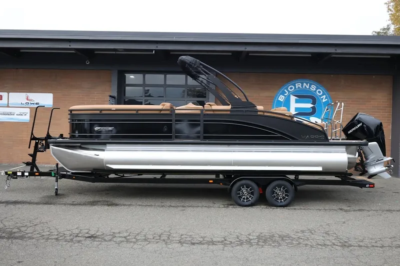 The Image of 2026 Harris Solstice 250 SL pontoon boat on trailer, parked outside showroom. - 1
