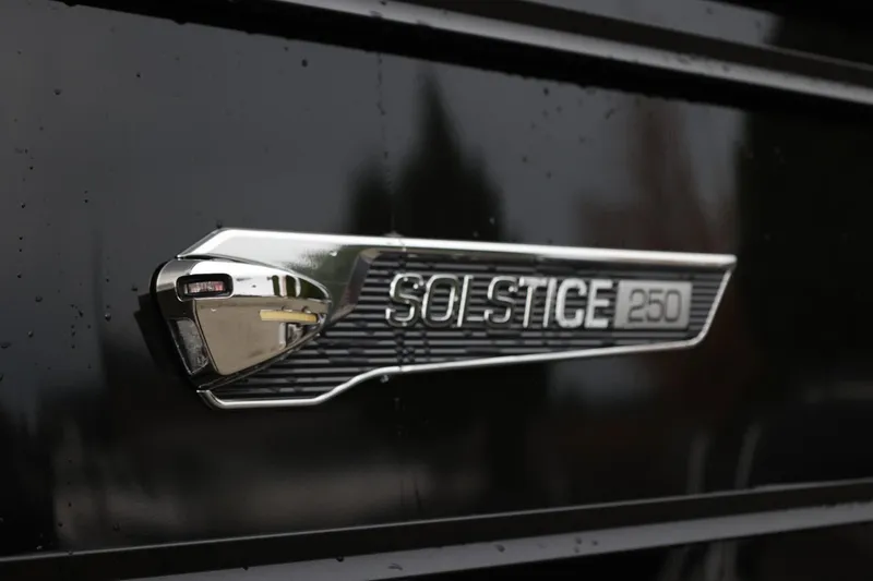 Slide: The Image of 2026 Harris Solstice 250 SL emblem on a sleek black surface. - 15