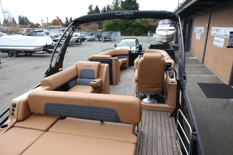 Slide: The Image of 2026 Harris Solstice 250 SL pontoon boat with luxurious tan seating and modern design. - 16
