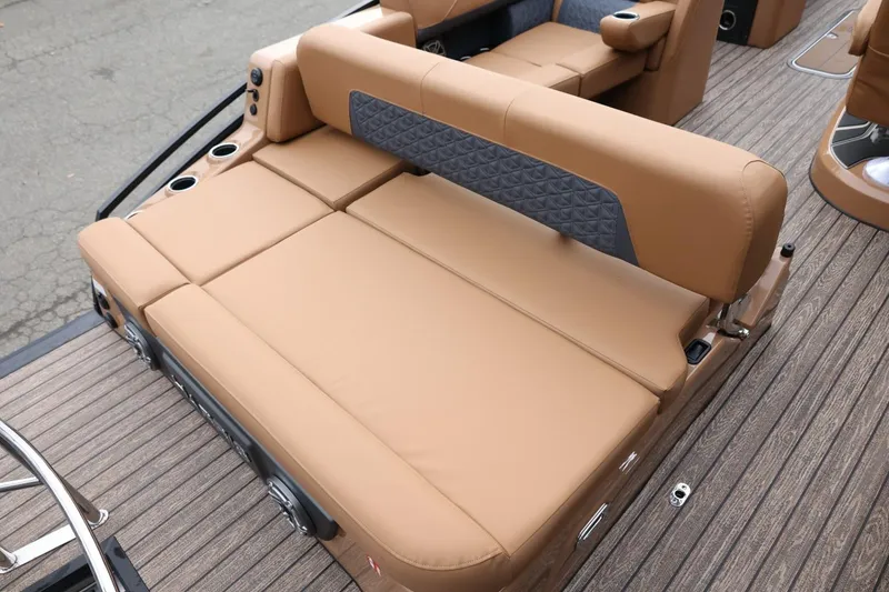 Slide: The Image of Luxurious seating on 2026 Harris Solstice 250 SL boat with tan upholstery and cup holders. - 18