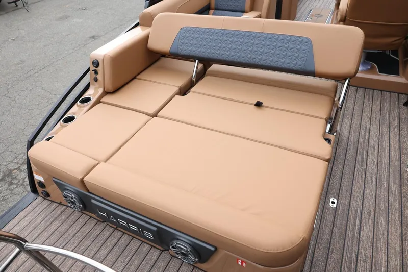 Slide: The Image of 2026 Harris Solstice 250 SL boat with luxurious tan seating and integrated speakers. - 20