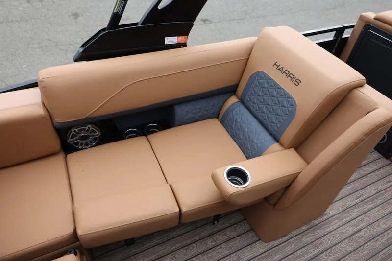 Slide: The Image of Luxurious seating on 2026 Harris Solstice 250 SL boat with tan upholstery and cup holder. - 22