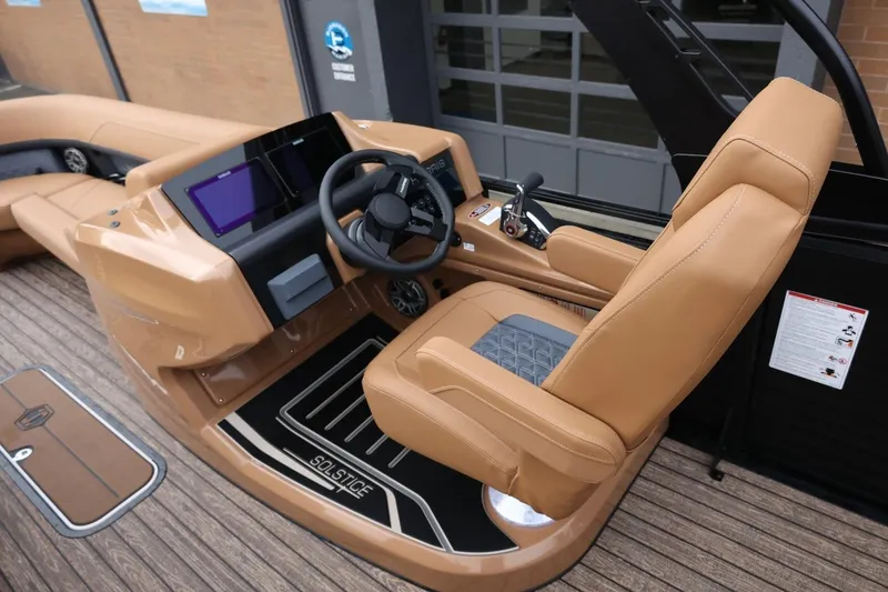 Slide: The Image of 2026 Harris Solstice 250 SL boat interior with tan leather seating and modern dashboard. - 23