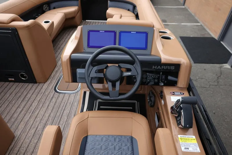 Slide: The Image of 2026 Harris Solstice 250 SL boat interior with modern dashboard and dual screens. - 24