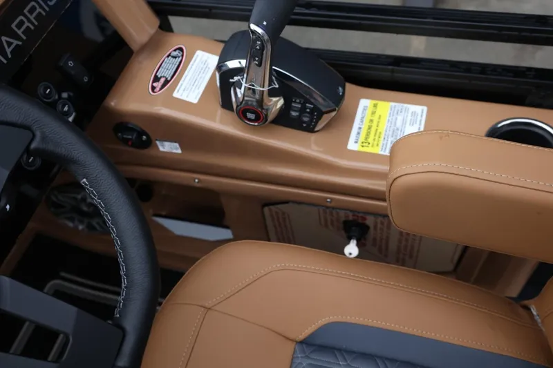 Slide: The Image of 2026 Harris Solstice 250 SL boat interior with tan leather seating and control panel. - 27