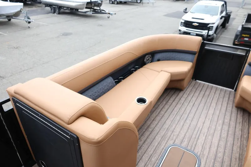 Slide: The Image of Luxurious seating on 2026 Harris Solstice 250 SL pontoon boat, featuring tan upholstery and wood flooring. - 33