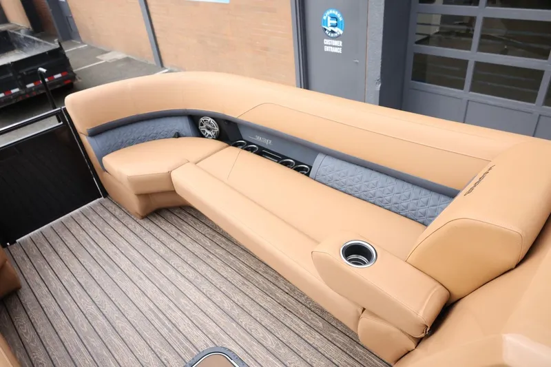 Slide: The Image of Luxurious seating on 2026 Harris Solstice 250 SL boat with tan upholstery and wood-style flooring. - 34