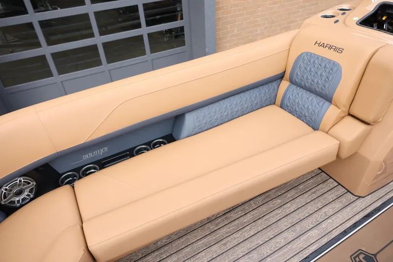 Slide: The Image of Luxurious seating on 2026 Harris Solstice 250 SL boat, featuring tan and gray upholstery. - 35