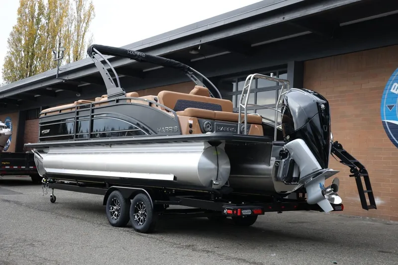 Slide: The Image of 2026 Harris Solstice 250 SL pontoon boat on trailer, featuring sleek design and powerful outboard motor. - 4