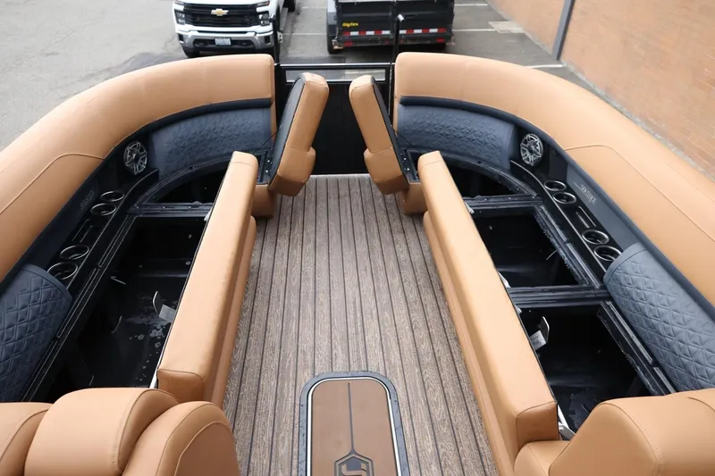 Slide: The Image of 2026 Harris Solstice 250 SL boat interior with tan seating and wood flooring. - 40