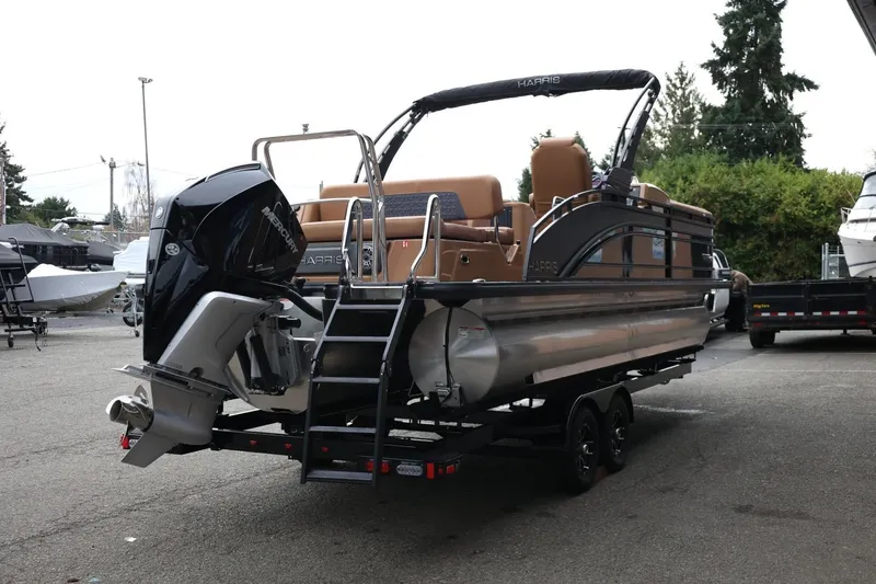 Slide: The Image of 2026 Harris Solstice 250 SL pontoon boat with Mercury engine on trailer. - 7