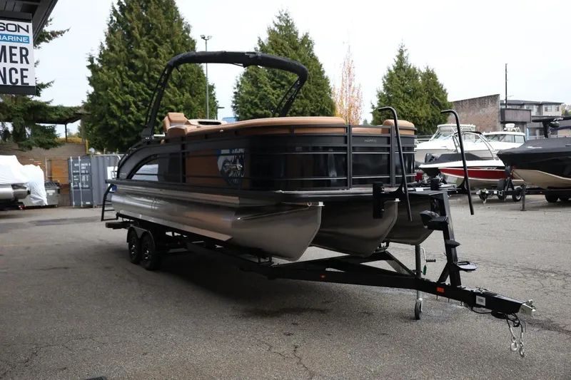 Slide: The Image of 2026 Harris Solstice 250 SL pontoon boat on trailer, parked outdoors. - 9