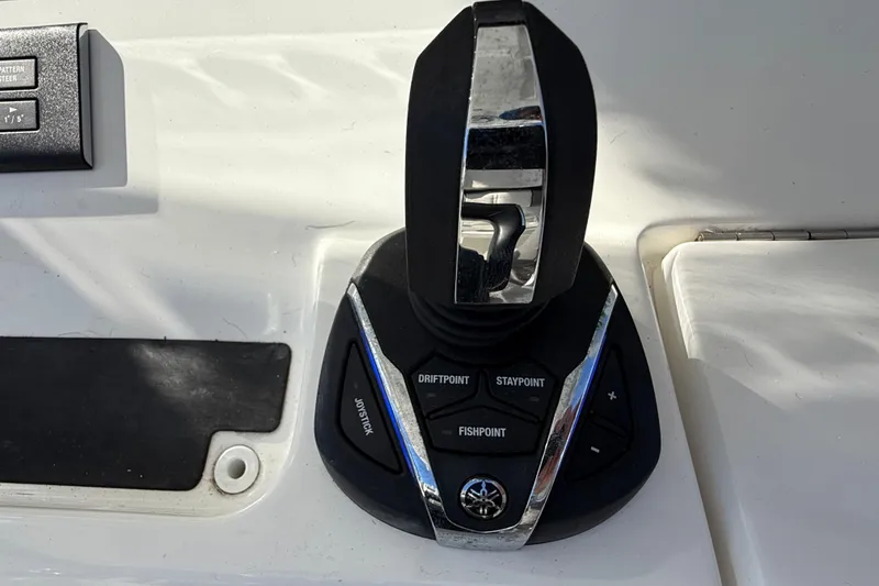 Slide: The Image of Joystick control panel on 2022 Regulator 34 boat, featuring drift and stay point functions. - 15