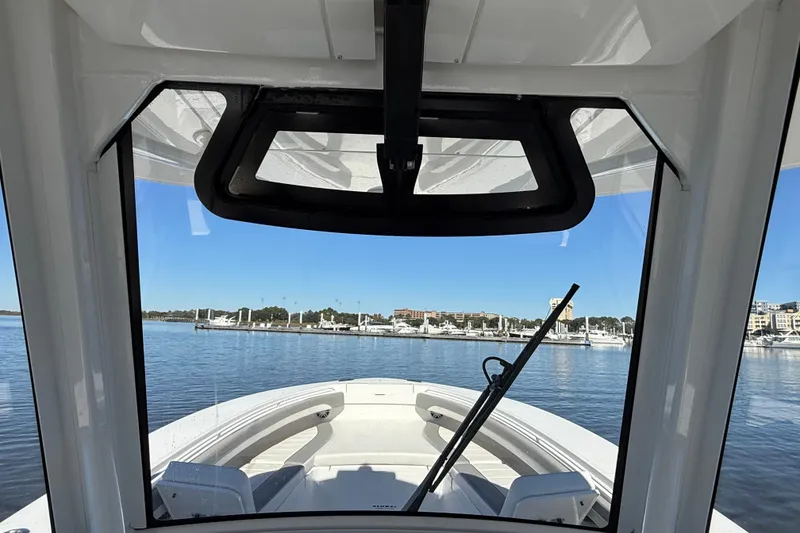 Slide: The Image of 2022 Regulator 34 boat interior view through windshield at marina. - 29