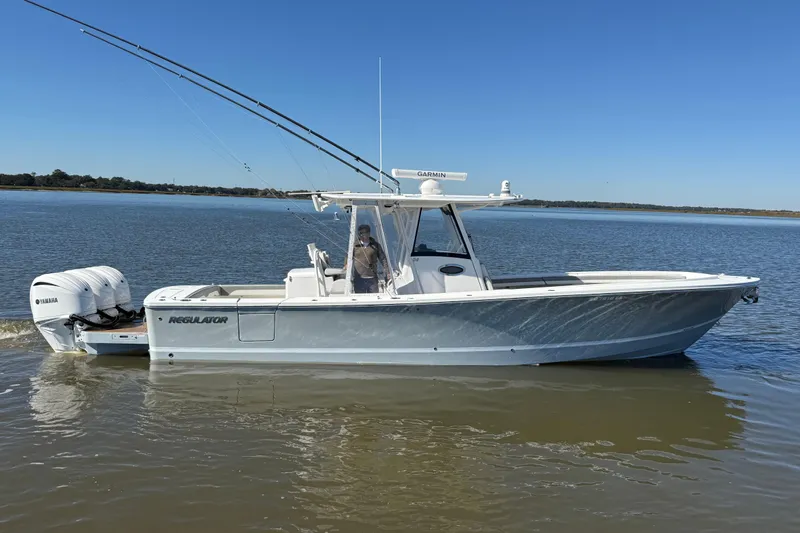 Slide: The Image of 2022 Regulator 34 boat with dual Yamaha engines on calm water. - 3