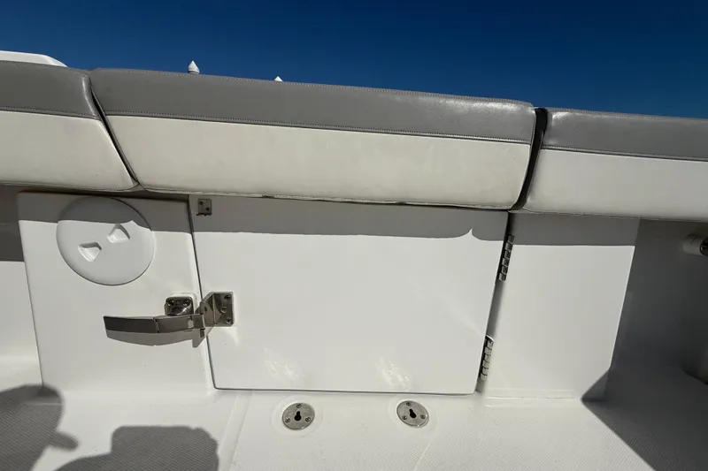Slide: The Image of 2022 Regulator 34 boat interior with cushioned seating and storage compartment. - 33