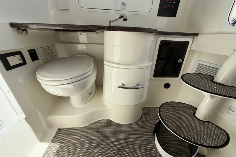 Slide: The Image of 2022 Regulator 34 boat interior with toilet, sink, and steps. - 35