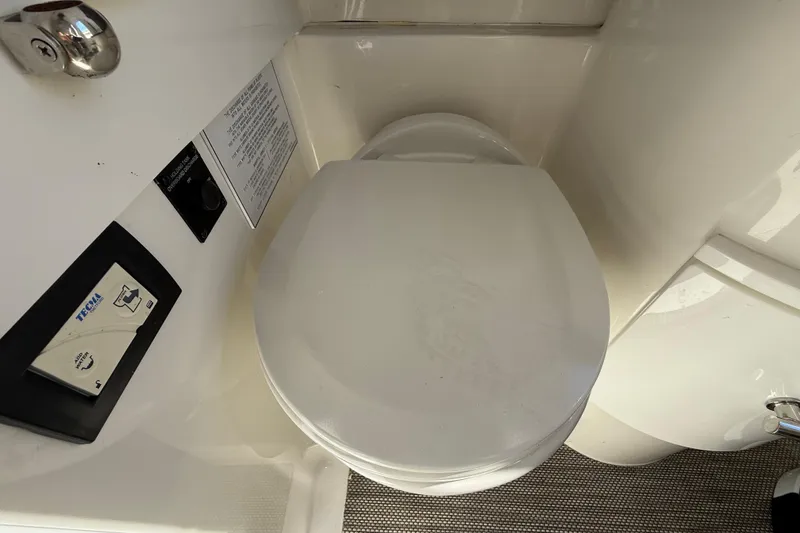 Slide: The Image of 2022 Regulator 34 boat bathroom with Tecma marine toilet and control panel. - 36