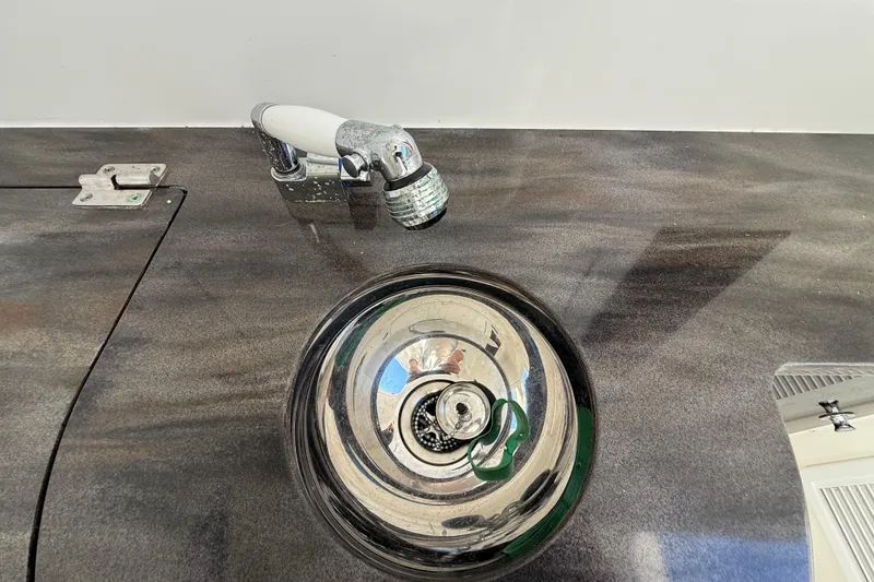 Slide: The Image of Stainless steel sink and faucet on 2022 Regulator 34 boat. - 38