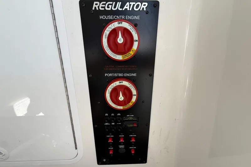 Slide: The Image of Control panel of a 2022 Regulator 34 boat with engine switches and indicators. - 41
