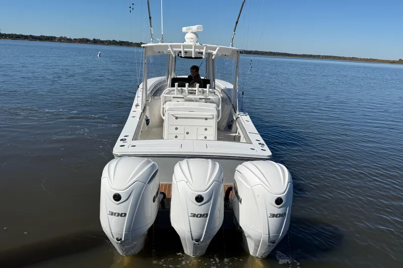 Slide: The Image of 2022 Regulator 34 boat with triple 300 horsepower engines on calm water. - 6