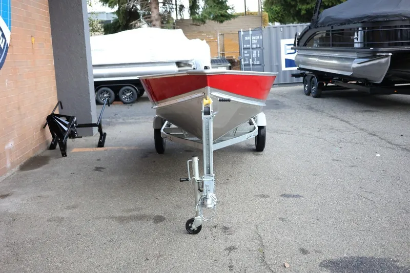 Slide: The Image of 2026 Lund SSV-16 Tiller boat on trailer, parked outdoors. - 12