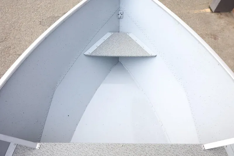 Slide: The Image of 2026 Lund SSV-16 Tiller boat interior, showcasing the bow area with textured flooring. - 21