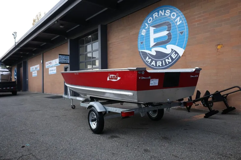 Slide: The Image of 2026 Lund SSV-16 Tiller boat on trailer at Bjornson Marine dealership. - 4