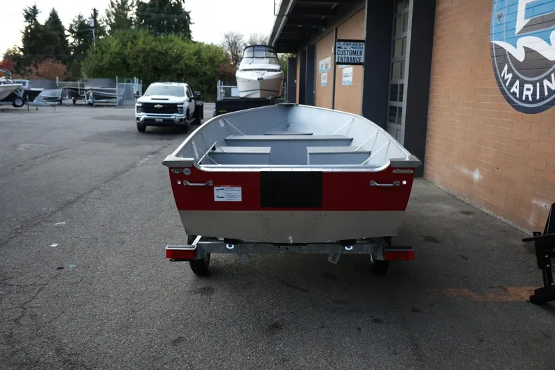 Slide: The Image of 2026 Lund SSV-16 Tiller boat on trailer in marina parking lot. - 5