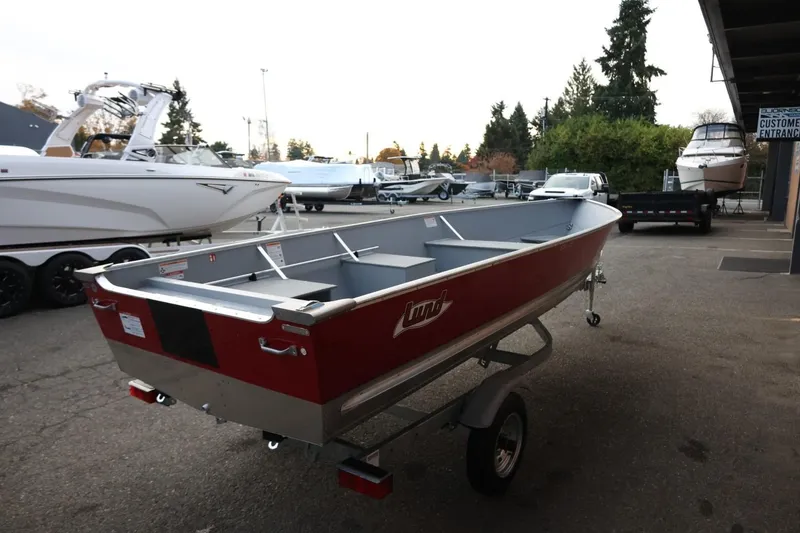 Slide: The Image of 2026 Lund SSV-16 Tiller boat on trailer in outdoor showroom setting. - 8