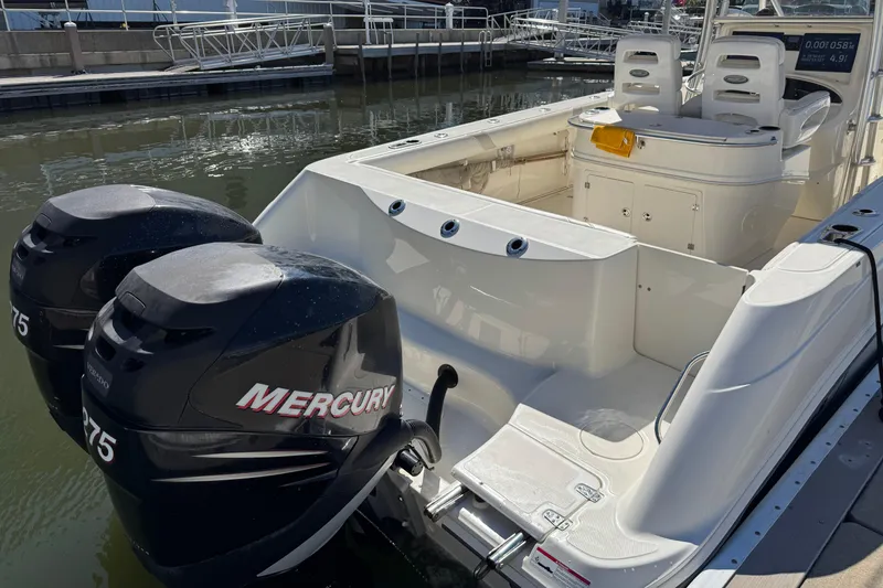 Slide: The Image of 2006 Boston Whaler 320 Outrage with twin Mercury 275 engines docked at marina. - 13