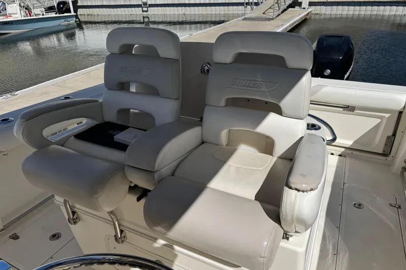 Slide: The Image of 2006 Boston Whaler 320 Outrage boat seats, white leather, docked at marina. - 15