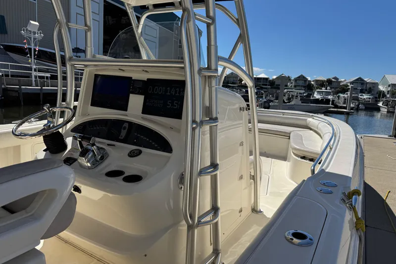 Slide: The Image of 2006 Boston Whaler 320 Outrage boat interior with helm and marina view. - 17